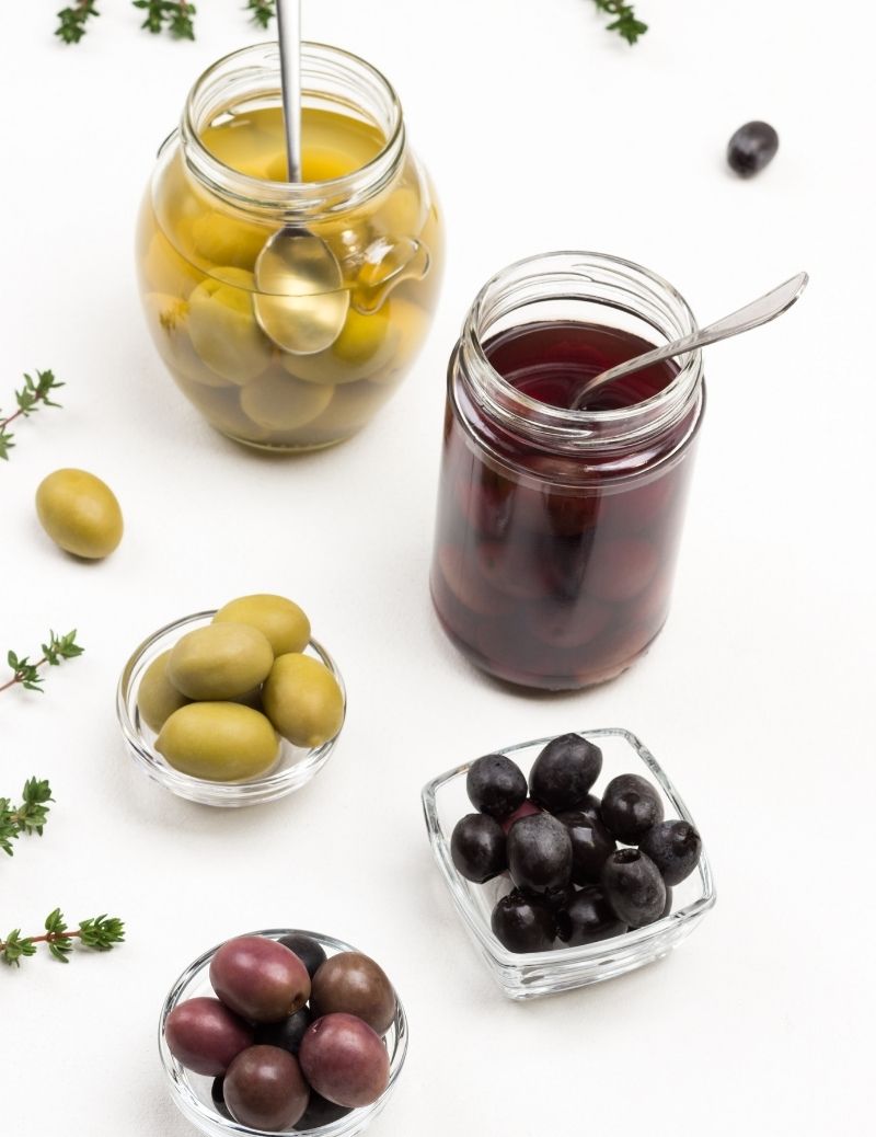 Black and Green Olives in cans and plates