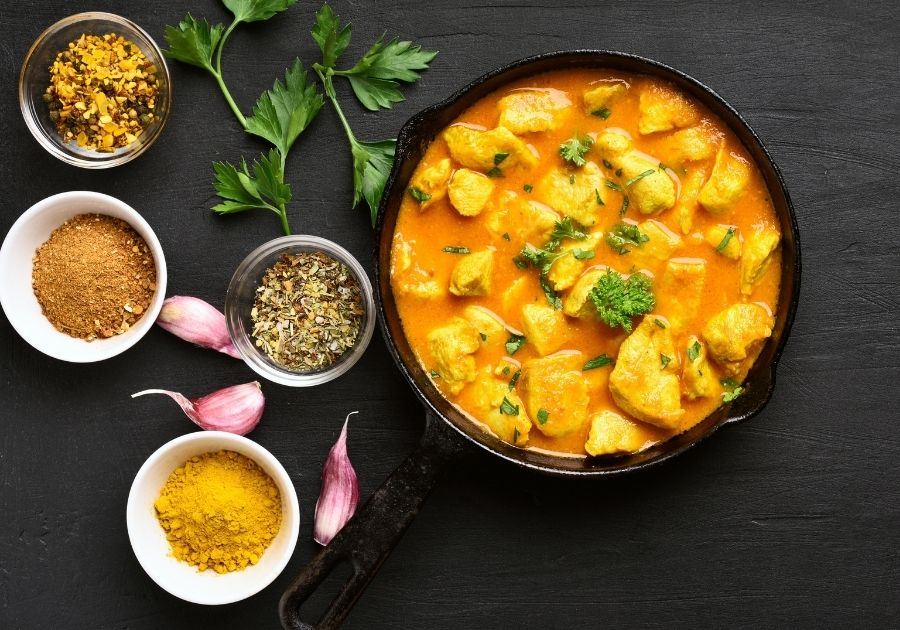 Chicken Curry Dish With Spices By The Side