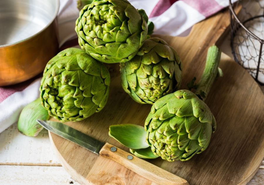 Fresh Green Artichokes on Cutting Board