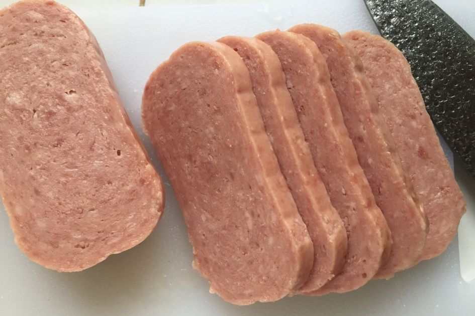 Slices of uncooked spam on the table